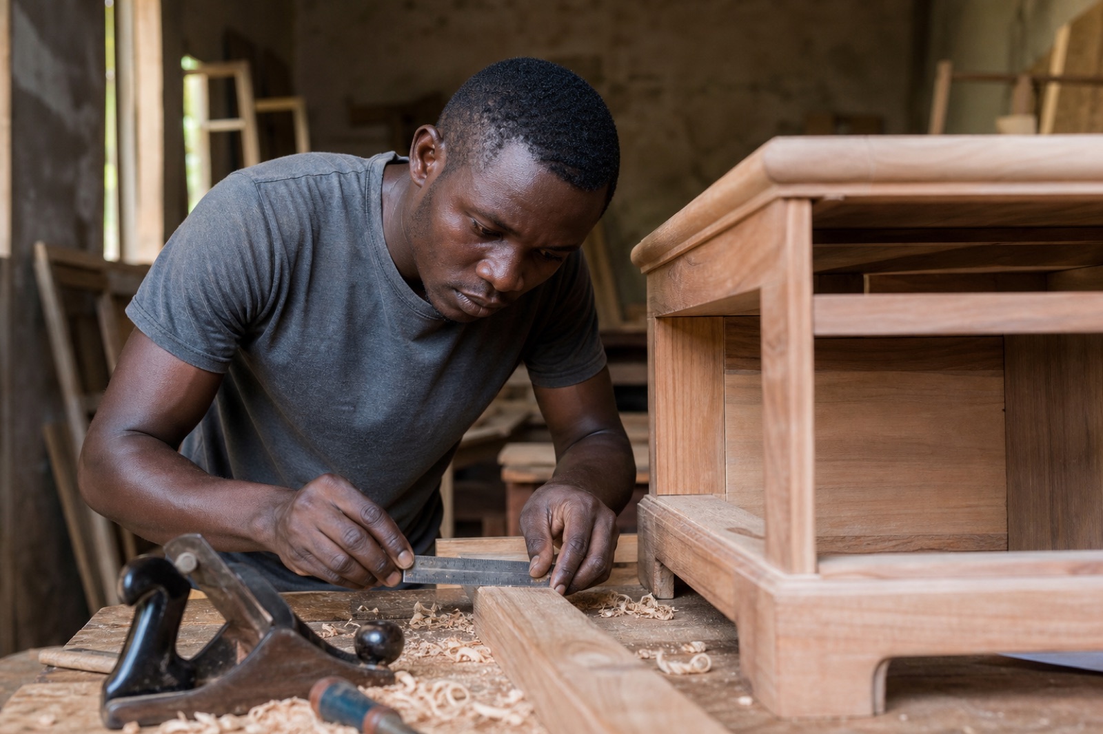 Carpenter crafting a wooden furniture piece in a workshop
